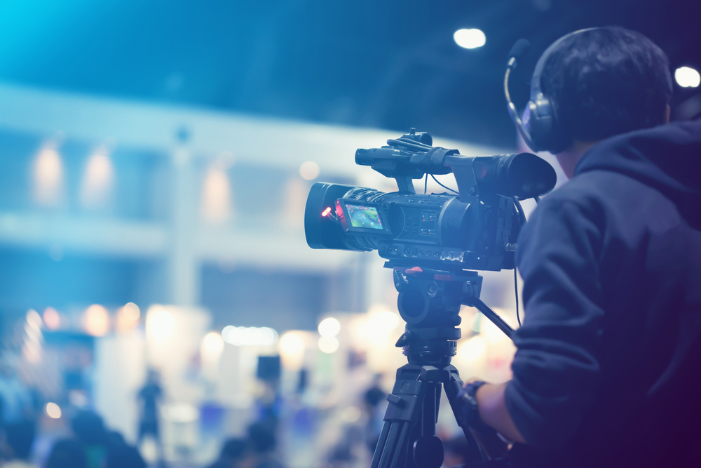 Professional video technician at an event, showcasing the importance of quality audio video components for event success.
