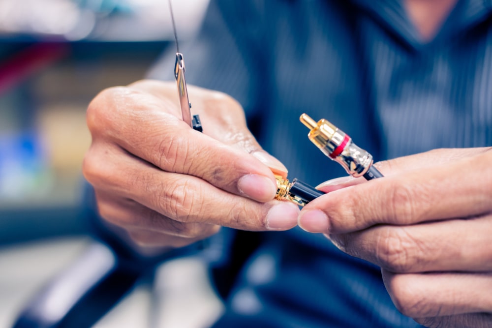 Expertly repairing and adjusting RCA cable equipment to enhance the audio experience, a service provided by your trusted audio visual equipment supplier.